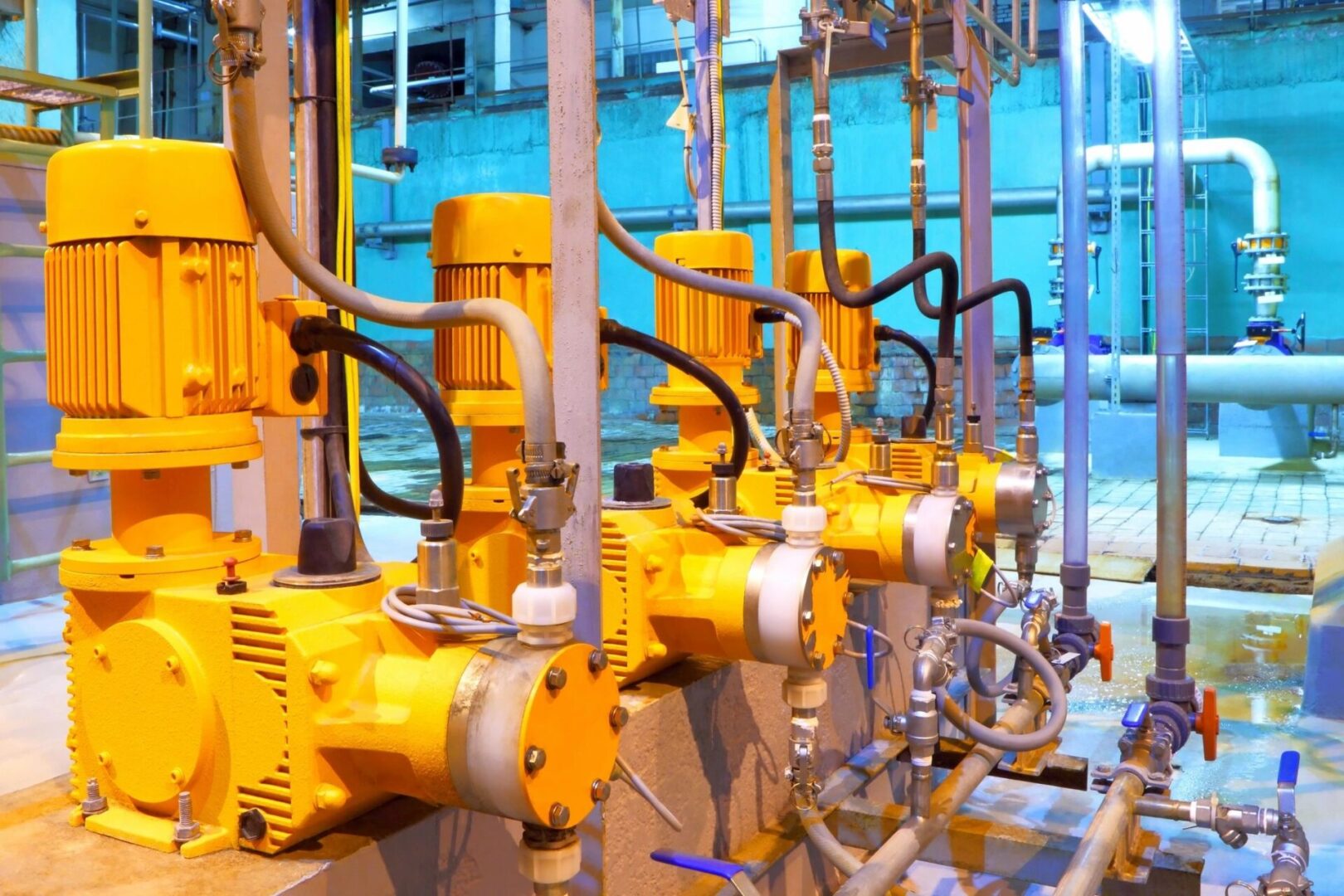 Four yellow machines working side by side inside a company